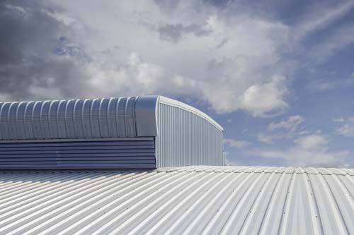 Closeup of white metal commercial roof in sun