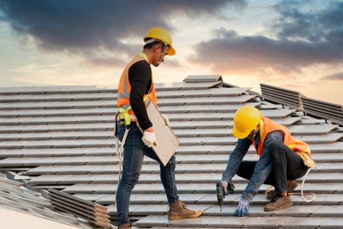 Team members working on roof.
