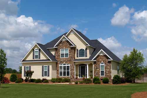 front yard view of large stone house